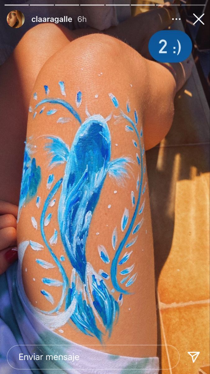 a woman with blue paint on her back