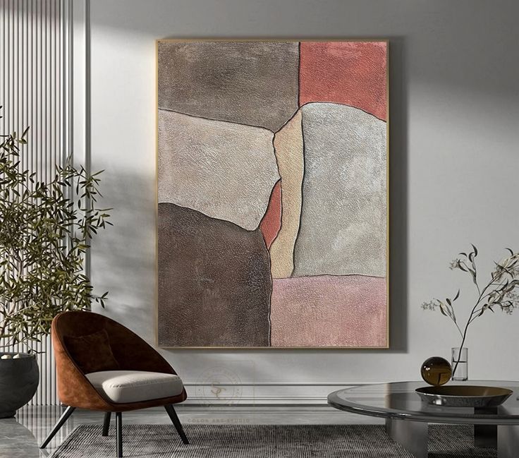 an abstract painting hangs on the wall above a glass table