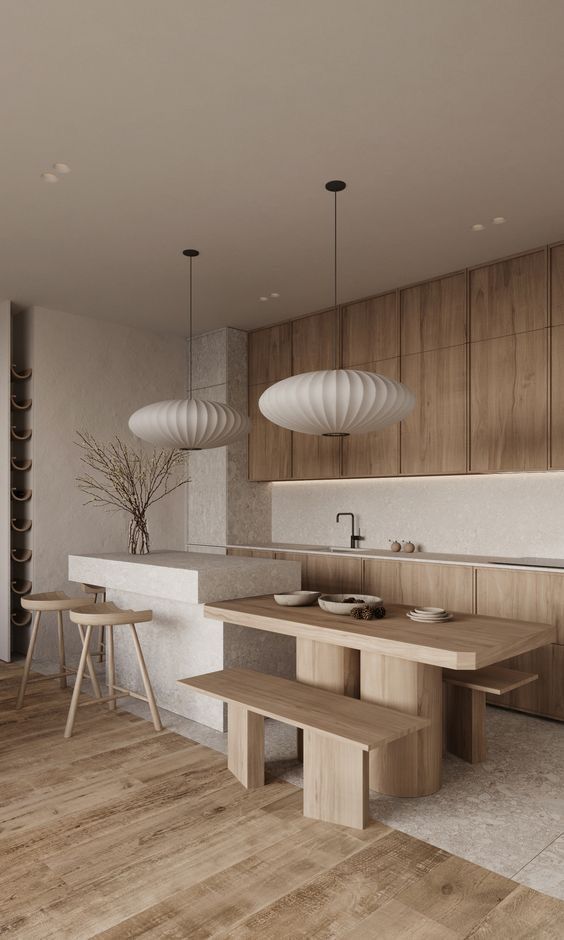 a modern kitchen with wooden cabinets and white counter tops, along with two pendant lights hanging from the ceiling