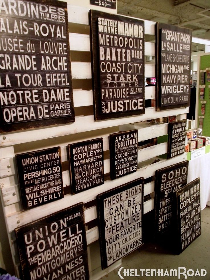 several black and white signs hanging on the wall in a room with tables, chairs and other items