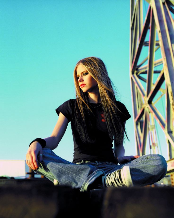 a woman sitting on the ground with her legs crossed