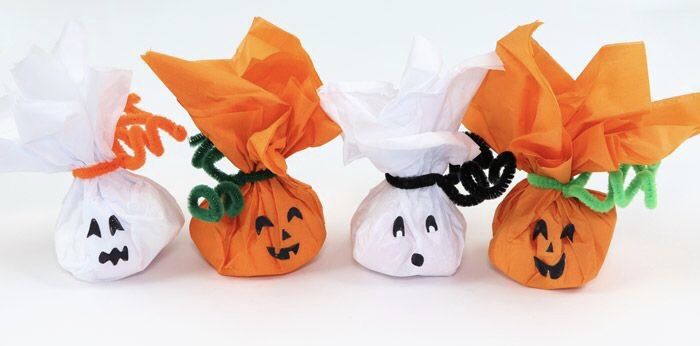 three small bags filled with candy sitting on top of a white table next to each other