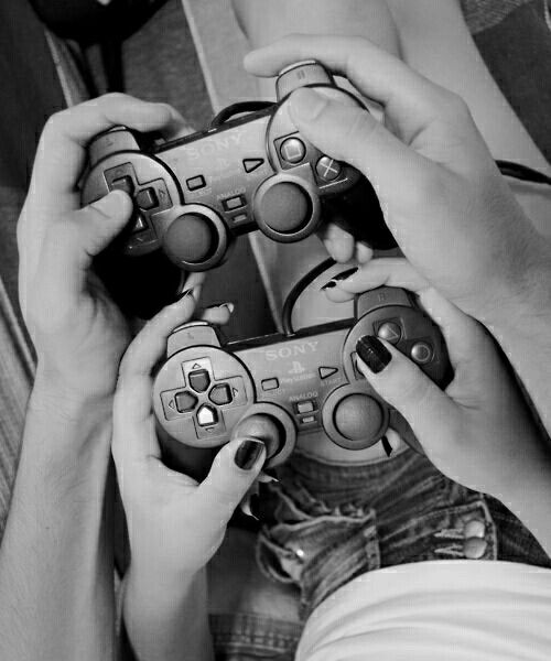 two people holding video game controllers in their hands