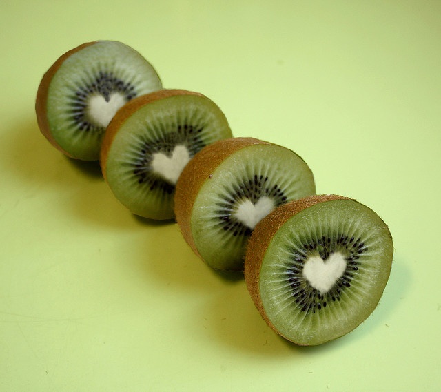 four kiwi slices with white heart in the middle