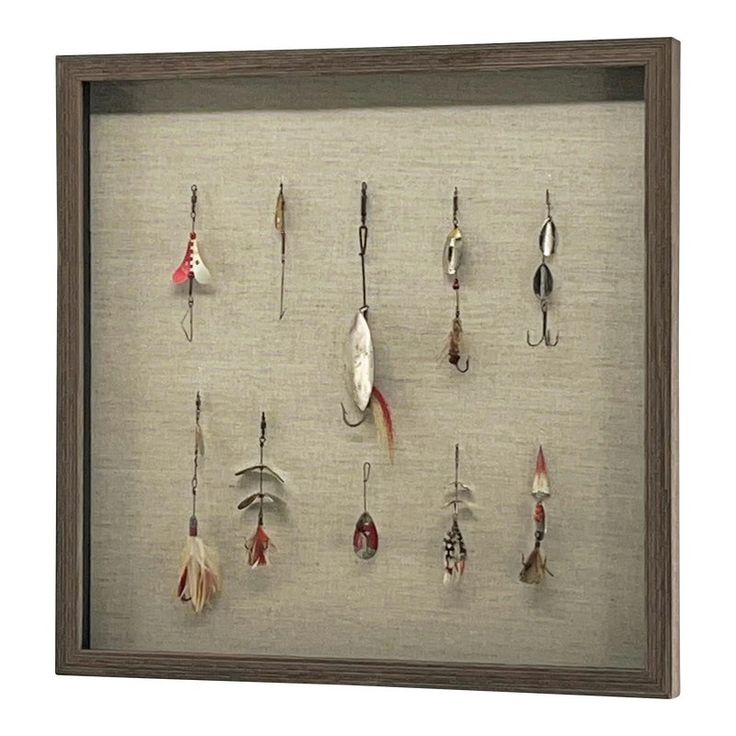 a shadow box frame with various fishing lures and hooks