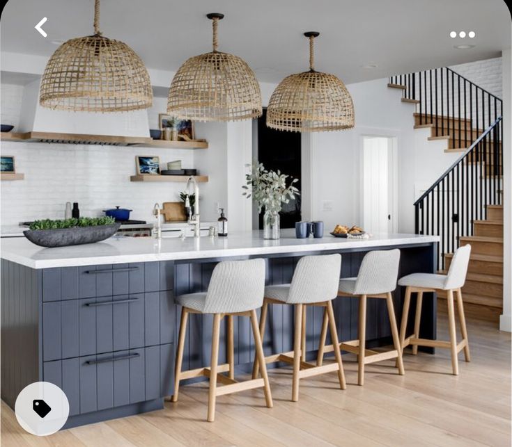 a kitchen with an island and bar stools