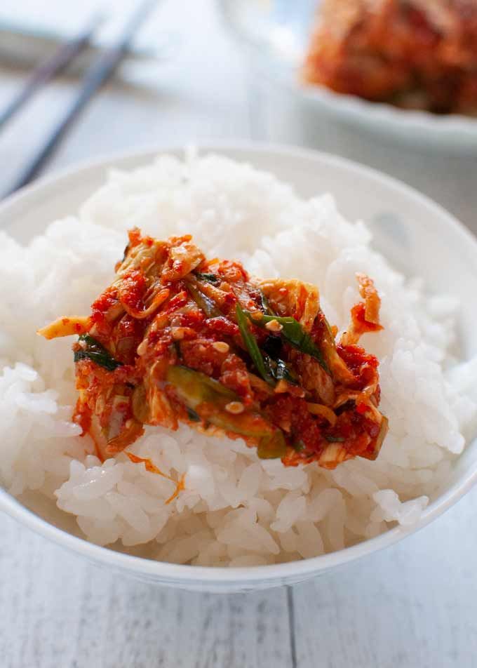 a white bowl filled with rice and meat