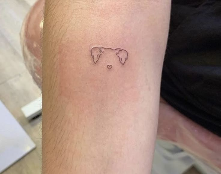 a small elephant tattoo on the arm