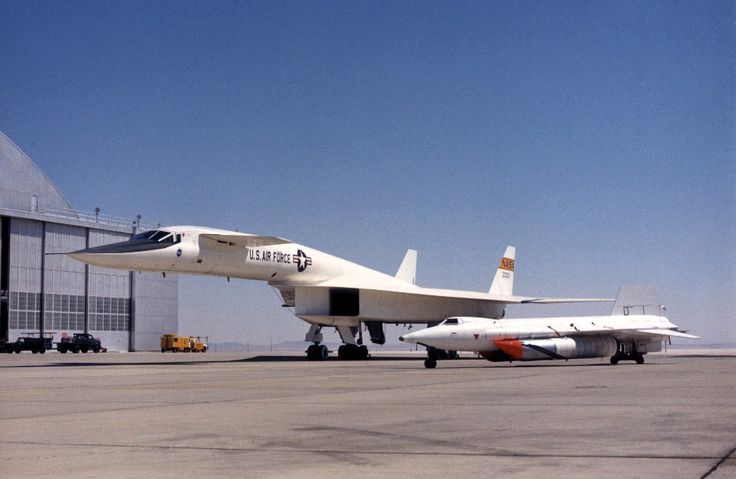 an airplane sitting on the tarmac with another plane in the back ground behind it