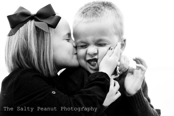 a woman kissing a young boy on the cheek