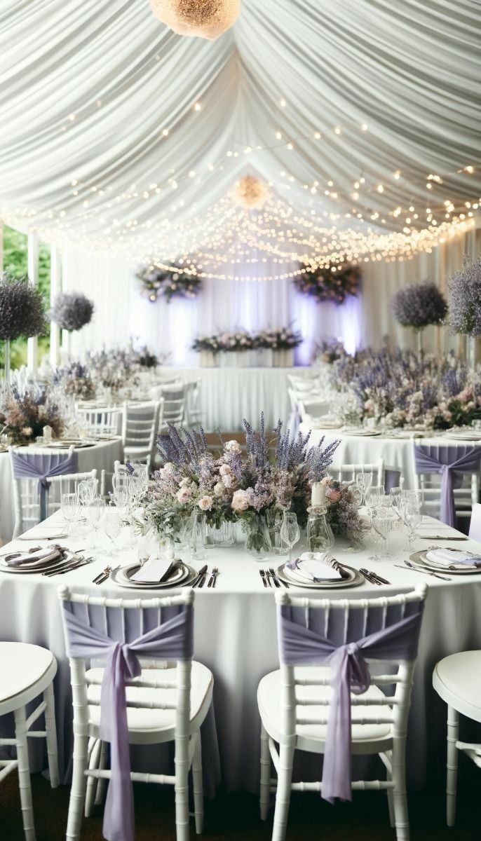 the tables are set with white chairs and purple flowers