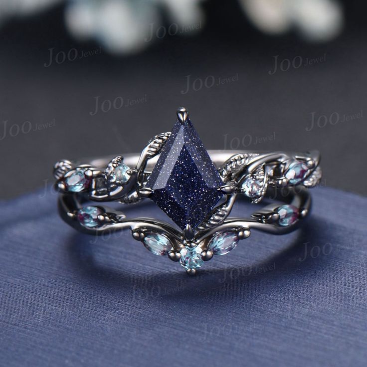 a close up view of a ring with blue stones