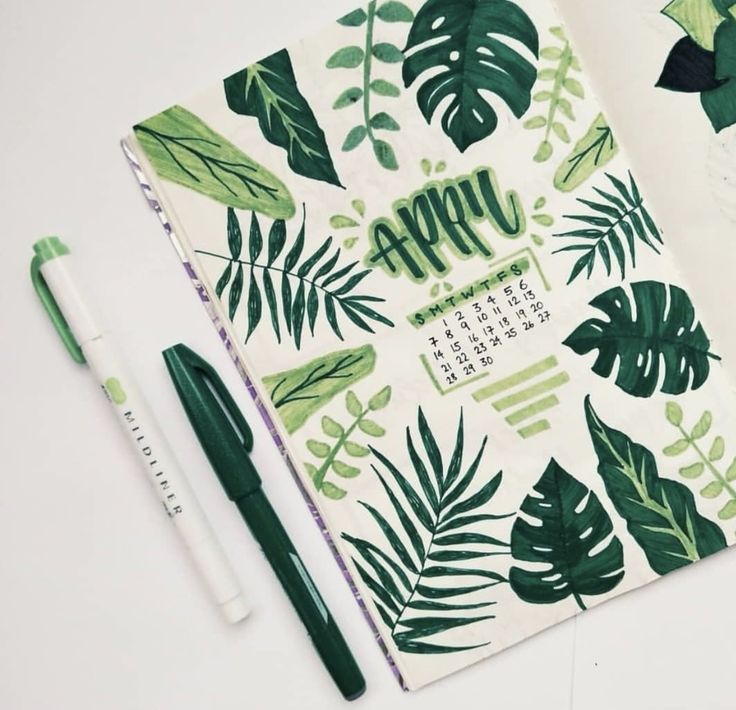 a green and white calendar with leaves on it