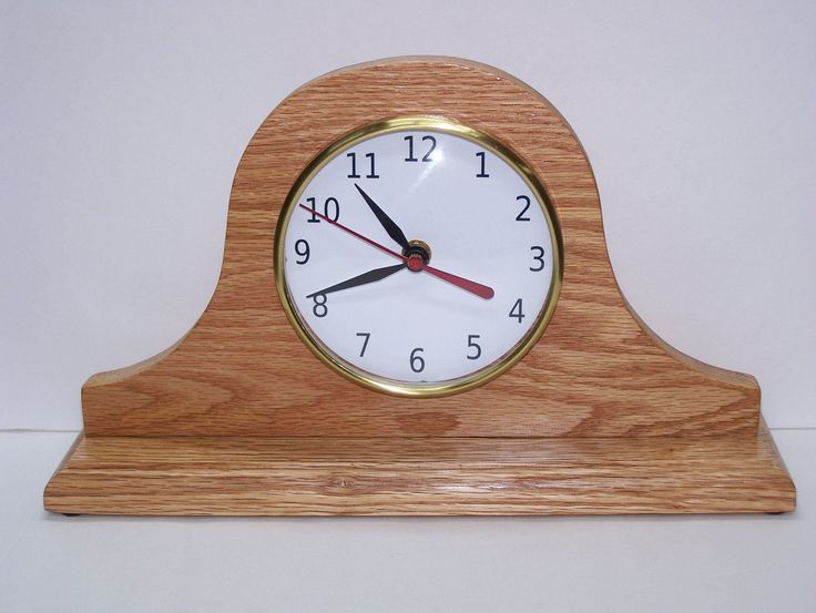 a small wooden clock sitting on top of a table