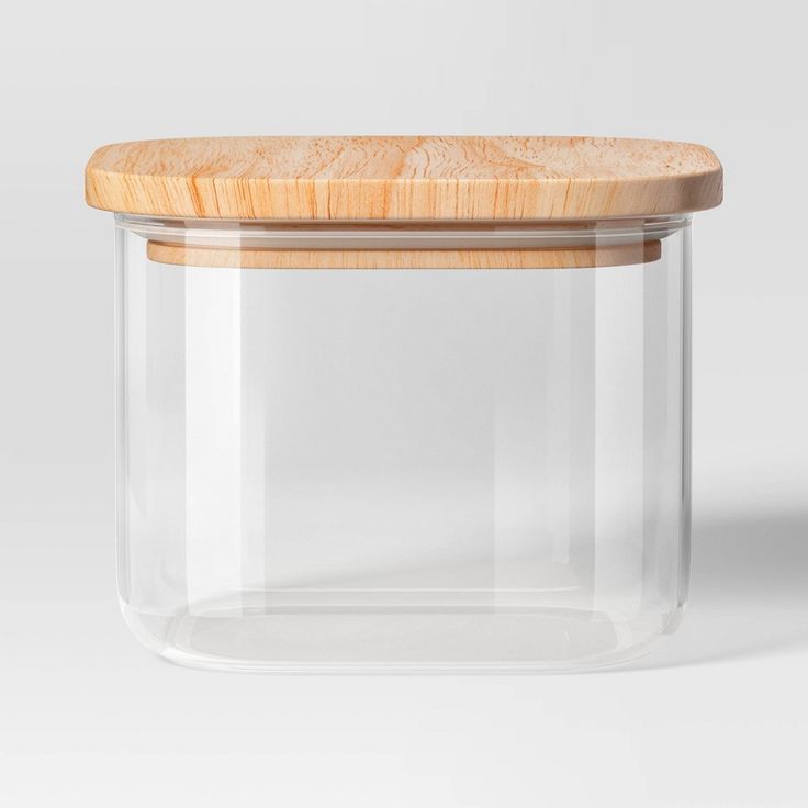 an empty glass jar with a wooden lid