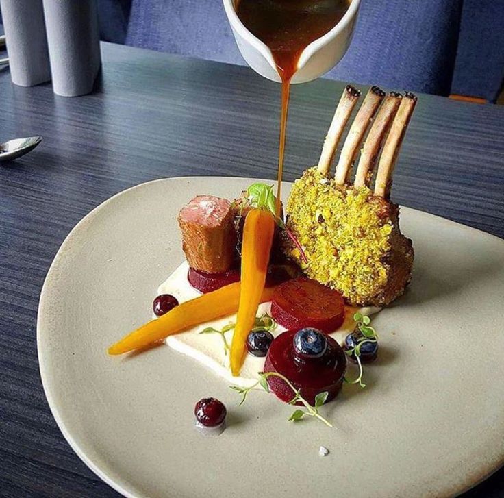 a white plate topped with food on top of a wooden table