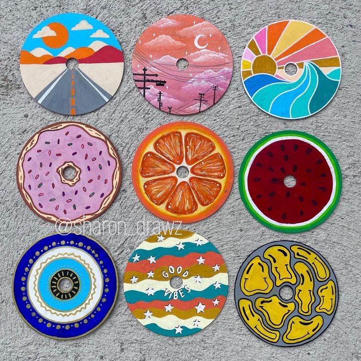 six different colored donuts are shown on the concrete surface, each with an individual's own design