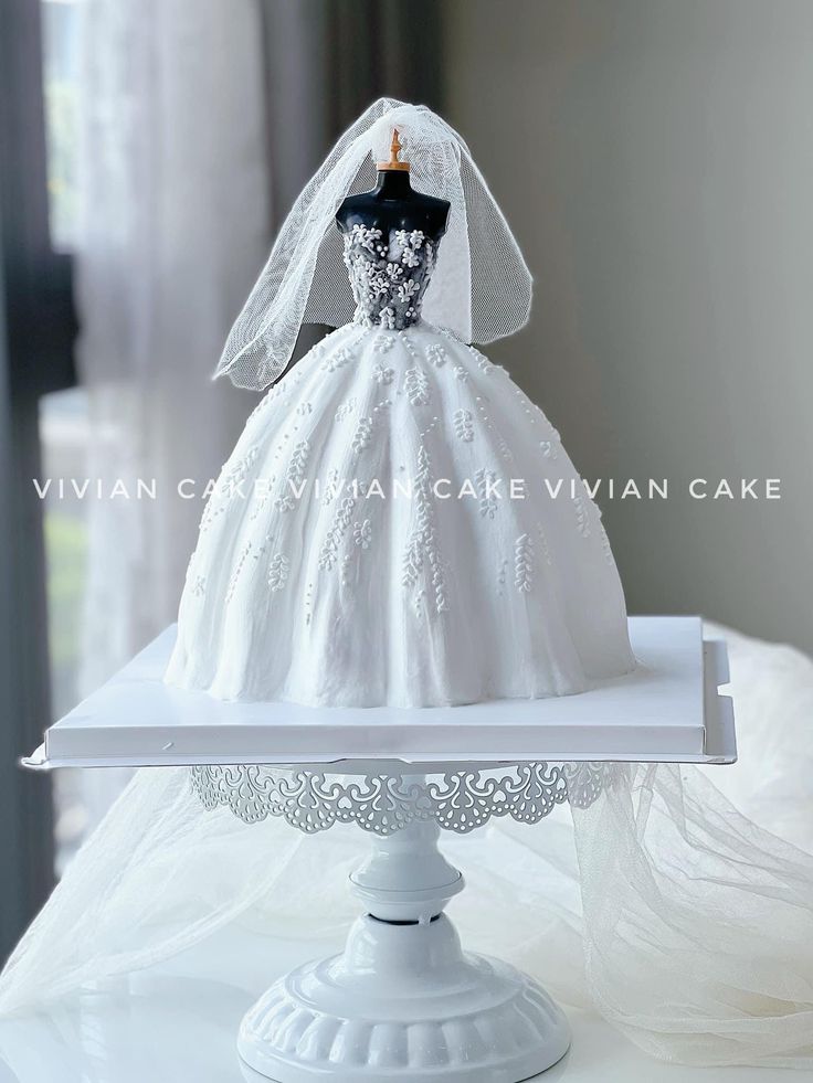 a white cake with a wedding dress on top