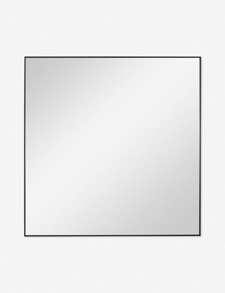 an empty square mirror on a white wall