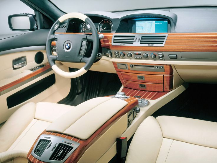 the interior of a modern car with wood trim and leather seats, including steering wheel