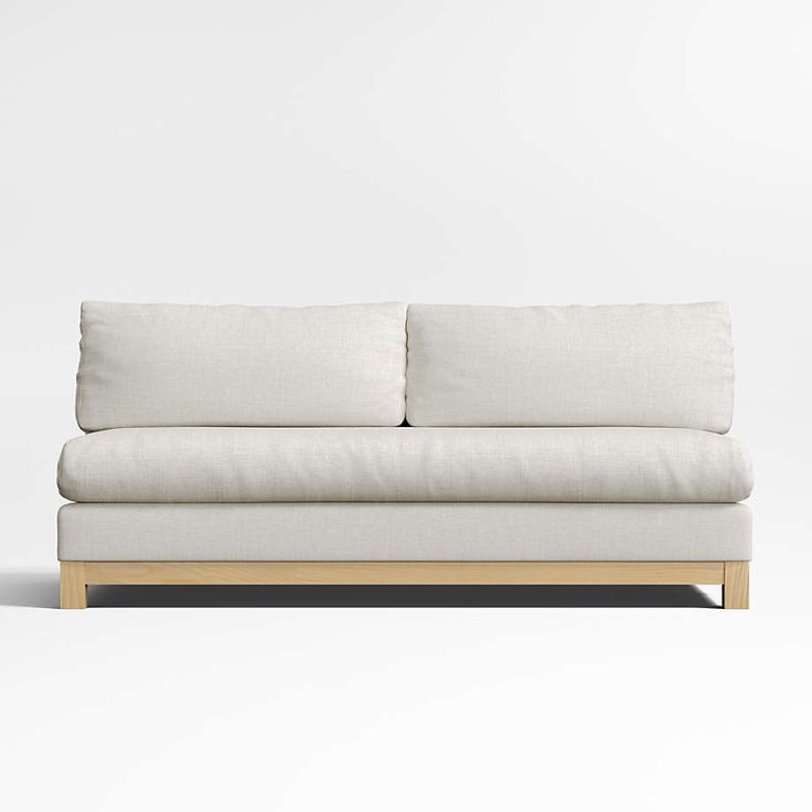 a white couch sitting on top of a wooden frame