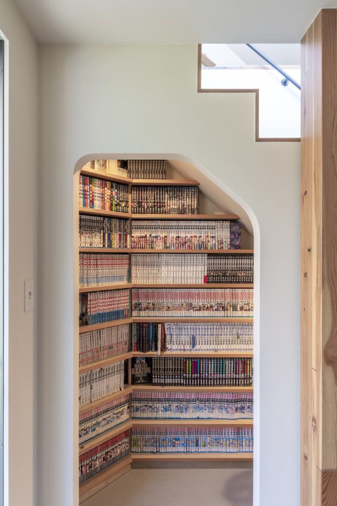 the bookshelf is made out of wood and has many different types of books on it