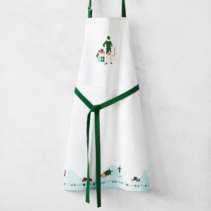 a white apron with green trim hanging on a wall