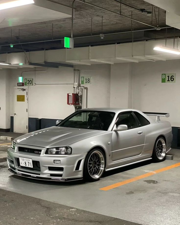 a silver car parked in a parking garage