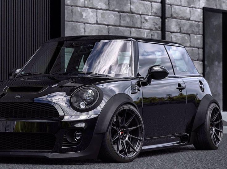 a black mini is parked in front of a building