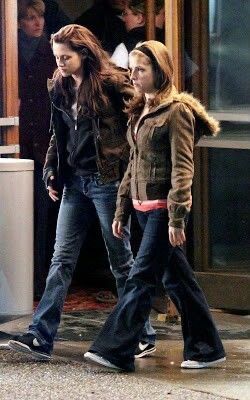 two young women walking down the street together