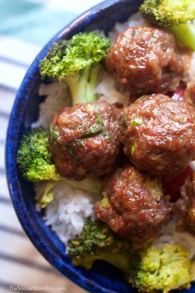 meatballs and broccoli on rice in a blue bowl