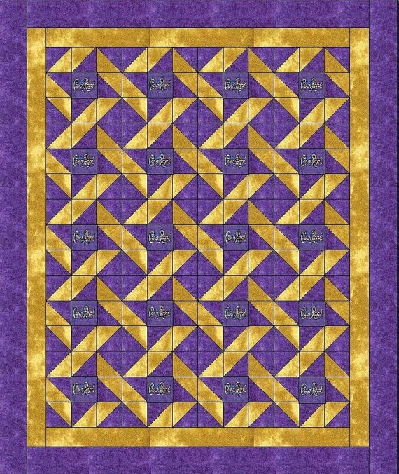 a purple and yellow quilt with gold triangles on the center, in front of a blue background