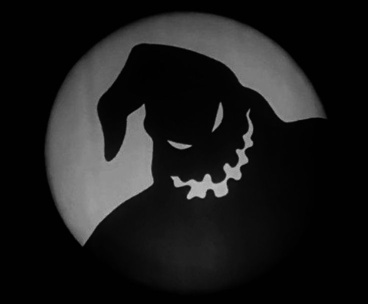 a black and white photo of a dog in the dark