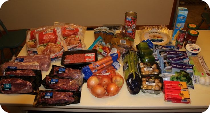 an assortment of food is laid out on a table with eggs, meats and vegetables