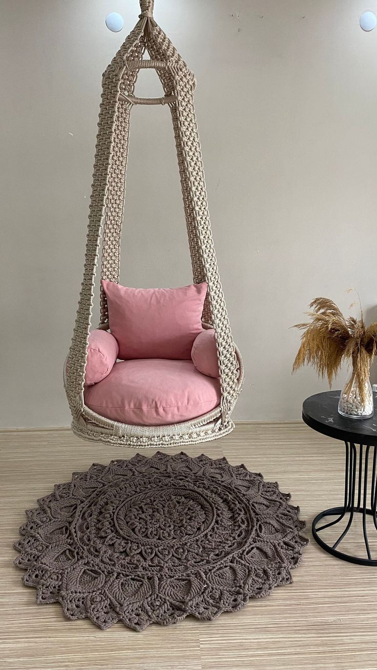 a living room with a chair and rug on the floor, next to a round table