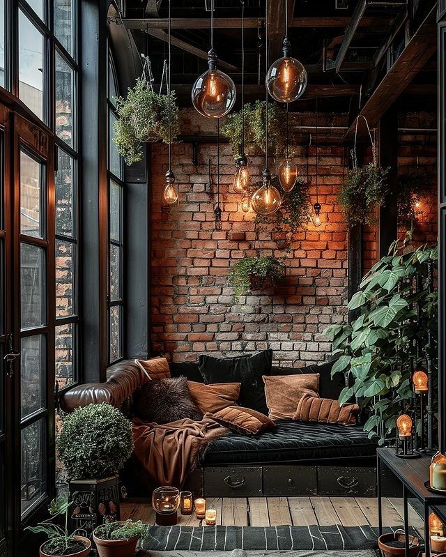 a living room filled with lots of plants and hanging light bulbs above the couches