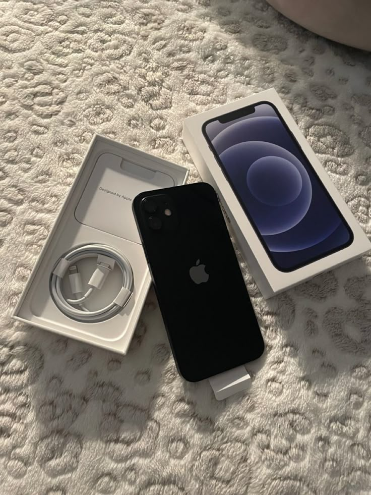 an apple iphone in its box on the floor next to it's charger