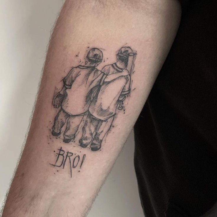 a man with a tattoo on his arm that says broo and two people wearing helmets