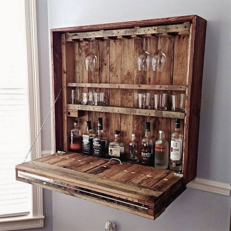 an old wooden box with bottles and glasses inside