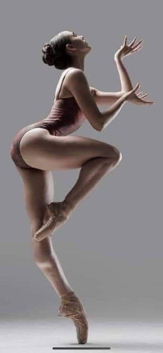 a woman in a bodysuit is dancing with her legs spread out to the side