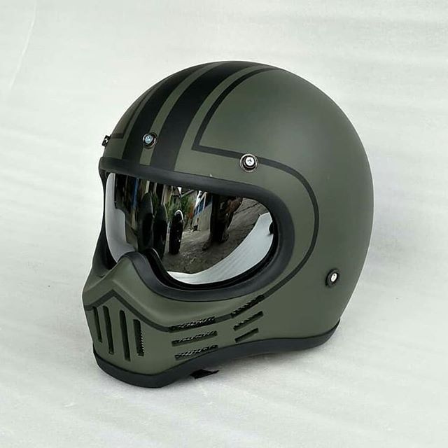 a helmet with goggles is shown on a white surface