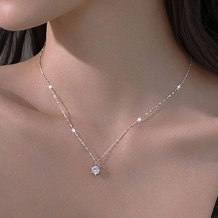 Discover the epitome of elegance and style with our New Trendy 925 Sterling Silver AAA Zircon Choker Necklace Collection. Crafted with meticulous attention to detail, these stunning necklaces exude a timeless charm that will captivate any woman's heart. Each necklace features a radiant AAA Zircon, a brilliant alternative to diamonds, exuding a dazzling shine that captures and reflects light from every angle. The 925 Sterling Silver chain adds a touch of sophistication, ensuring durability and a lasting shine. The minimalistic design of these choker necklaces embodies simplicity and versatility, making them perfect for any occasion. Whether worn solo for a subtle touch of glamour or layered with other necklaces for a trendy stacked look, these pieces effortlessly elevate any outfit. The CZ Cheap Silver Chain Necklaces For Women, Cheap Minimalist Silver Chain Necklace, Cheap Trendy Silver Choker, Cheap Delicate Silver Necklaces, Cheap Silver Dangle Rhinestone Necklace, Cheap Silver Chain Necklace For Parties, Cheap Silver Chain Necklace For Formal Occasions, Cheap Delicate Silver Chain Necklace, Cheap Pendant Necklace With Clavicle Chain