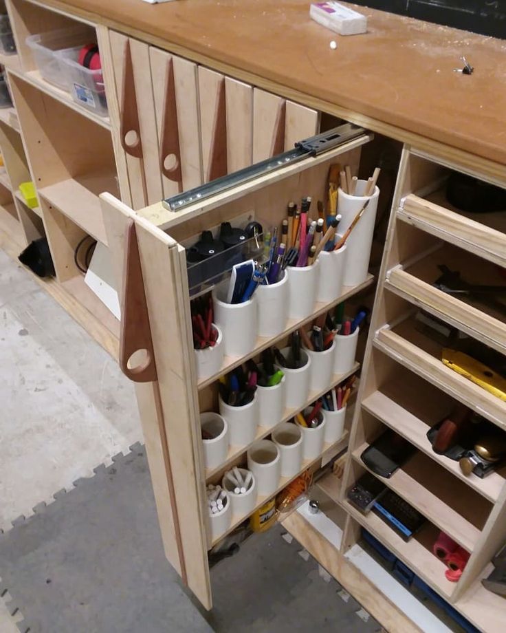 a wooden cabinet filled with lots of crafting supplies