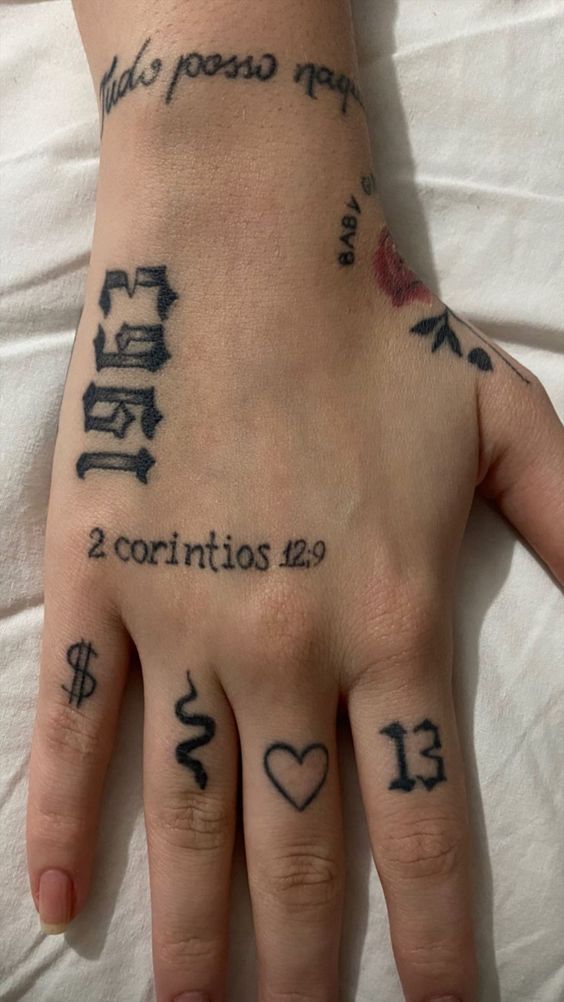 a person's hand with tattoos on it and two numbers written in different languages