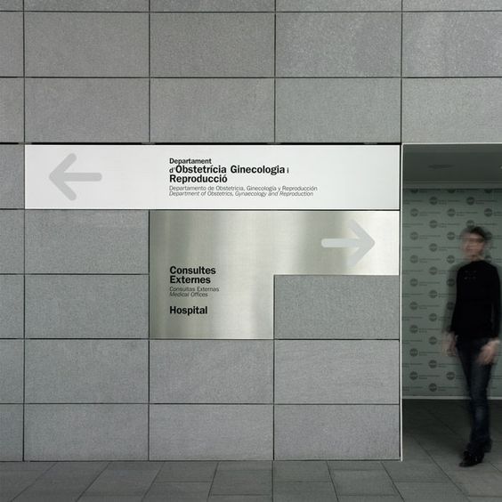 a man standing in front of a sign that says conduous externs hospital