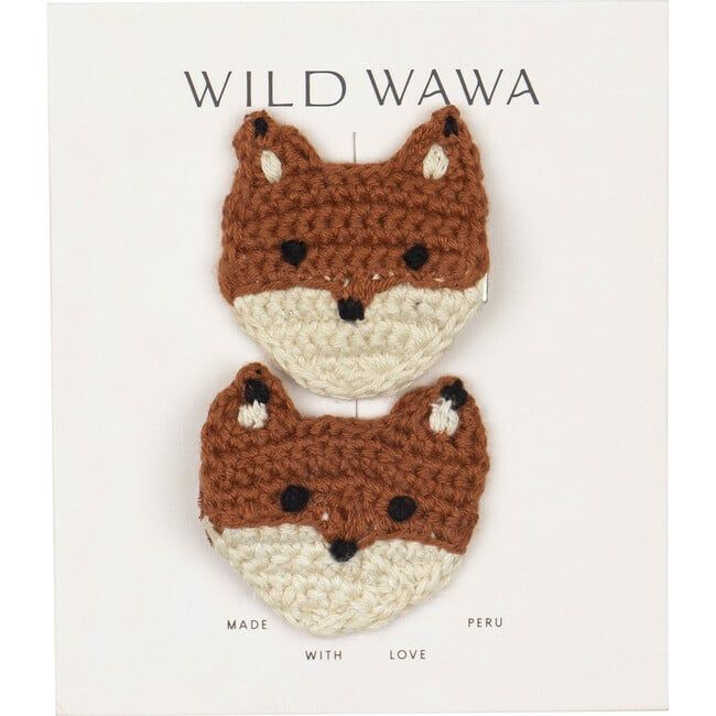 two crocheted fox head brooches are shown in front of a card