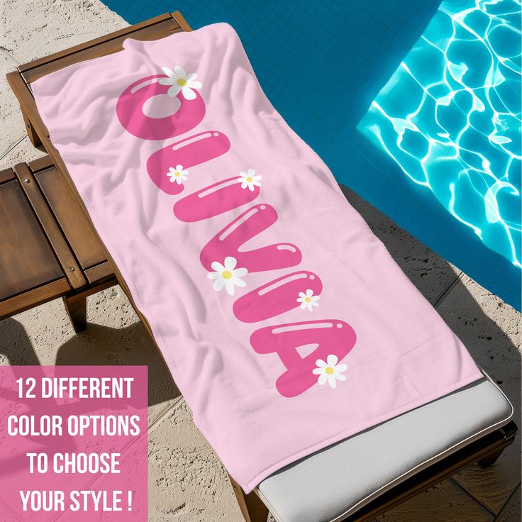 a beach towel with the word aona on it next to a pool and chair