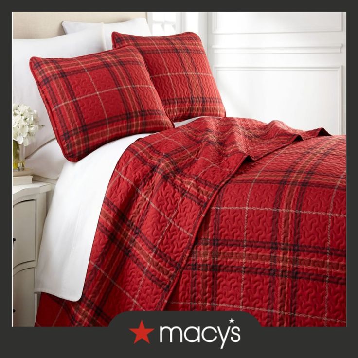 a red and black plaid comforter set on a bed