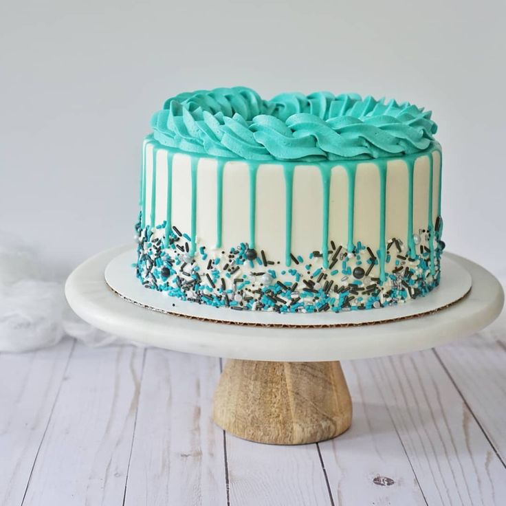 a cake with blue icing and sprinkles on top