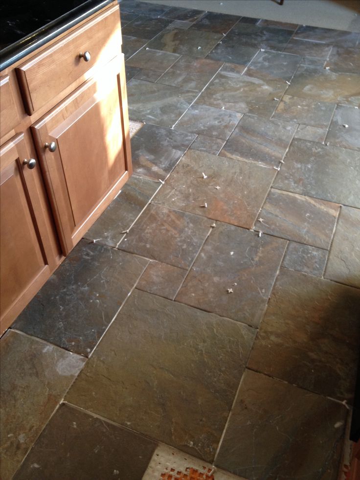 a kitchen floor that has been cleaned and is in the process of being remodeled with tile